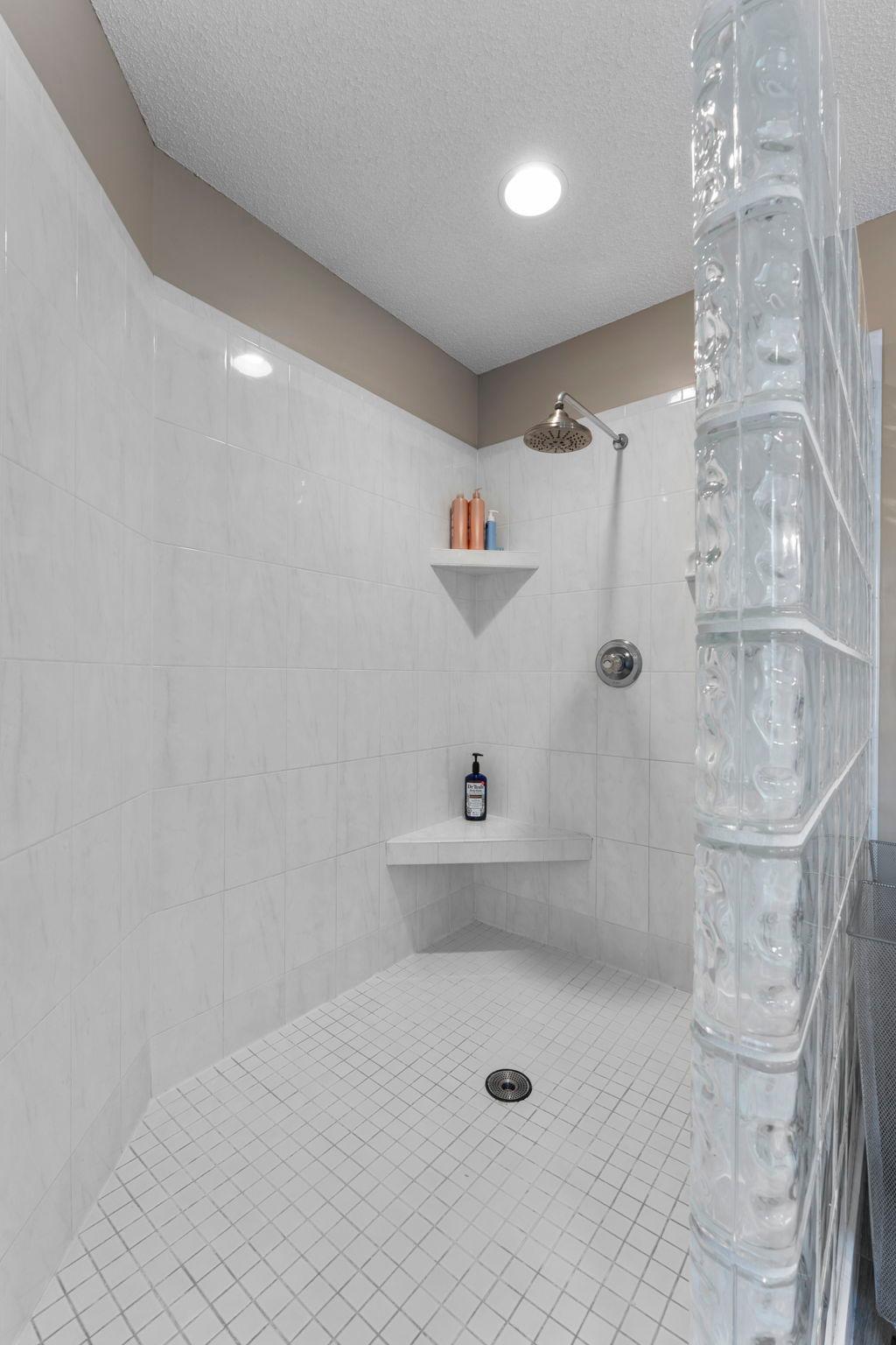 A look at the spacious tiled walk-in shower.