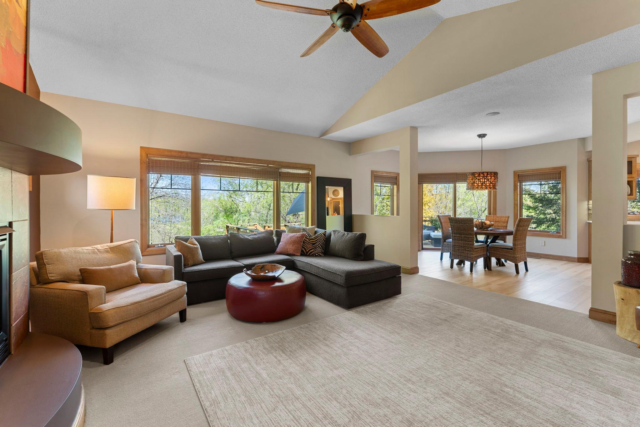Another view of the living room showcasing the adjacent informal dining and kitchen spaces.