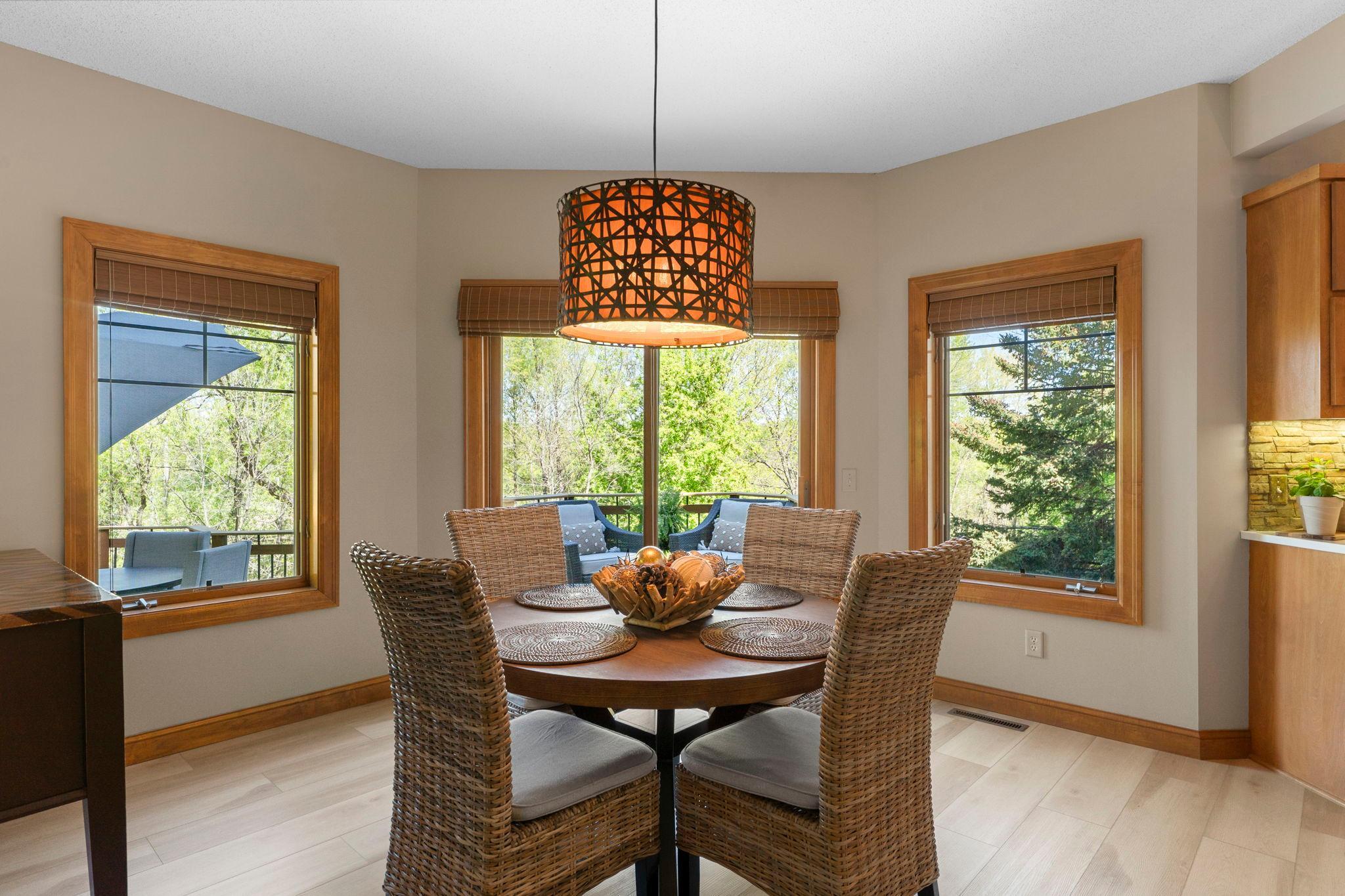 The kitchen opens effortlessly into the informal dining area, which provides access to a spacious two-tier maintenance-free deck.