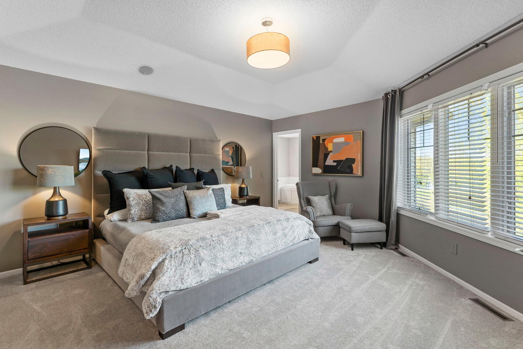 Upstairs offers three bedrooms, including a spacious primary suite with double wood doors, brand-new carpeting (2026), tray ceilings, and a large window.