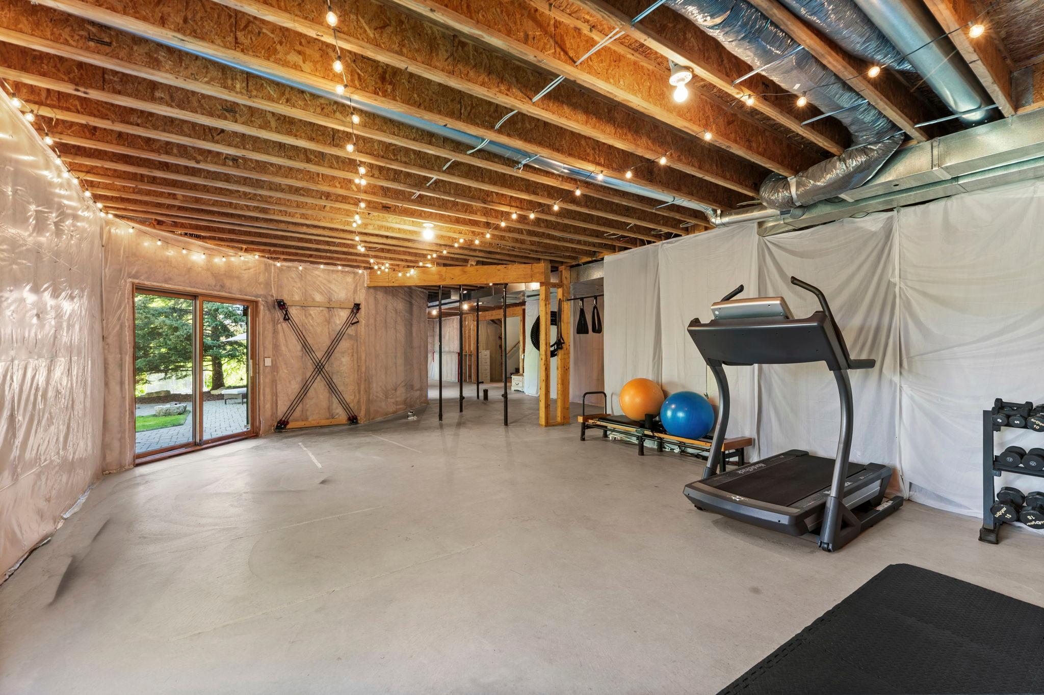 The lower level is currently unfinished, offering an incredible opportunity for future expansion and direct walkout access to the standout backyard.