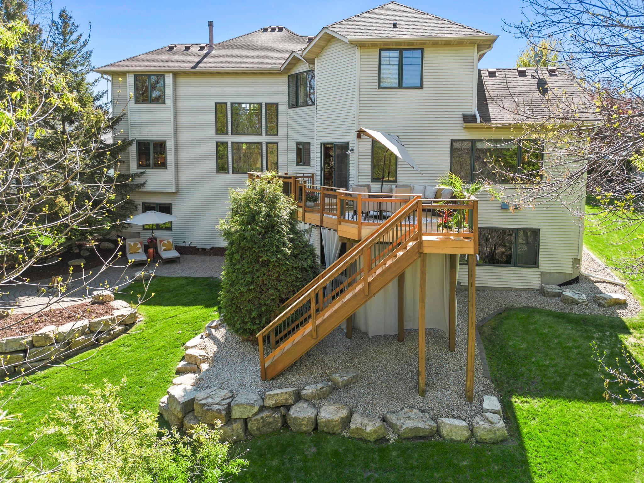 Limestone accents around the home and mature trees create a private, peaceful setting.