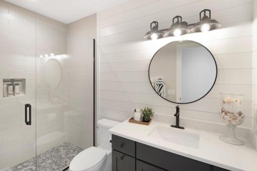 The lower-level 3/4 bathroom, conveniently located just steps from the bedrooms.