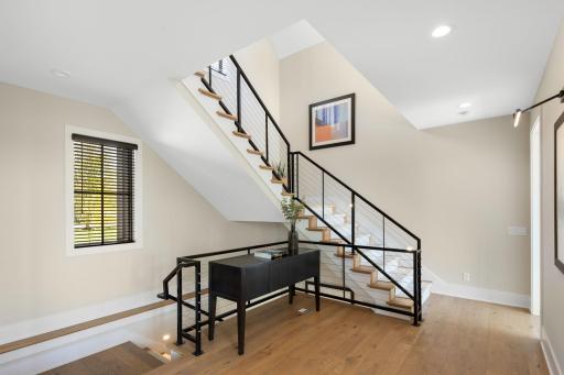 The stairs leading to the second upper-level wing, located on the opposite side of the home.