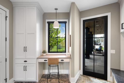 Also on the main level are the thoughtfully designed mudroom and laundry area, along with access to the attached three-car garage.
