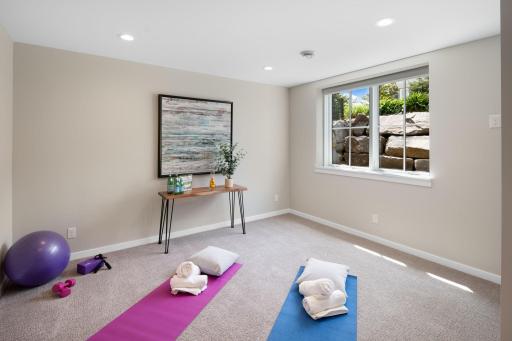 The third lower level bedroom is currently being used as a yoga/exercise room, adding versatility to the space.