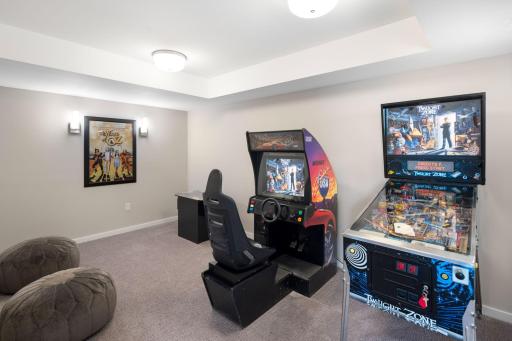 The lower-level recreation room offers carpeting, coved ceilings, and an 8x5 walk-in closet providing excellent additional storage. It also includes rough-in plumbing, offering the option to add a future bathroom if desired.