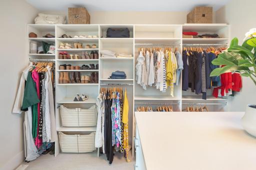The bathroom provides direct access to the impressive 12x12 walk-in closet, complete with custom built-ins and a center island with drawers to accommodate all your wardrobe needs.