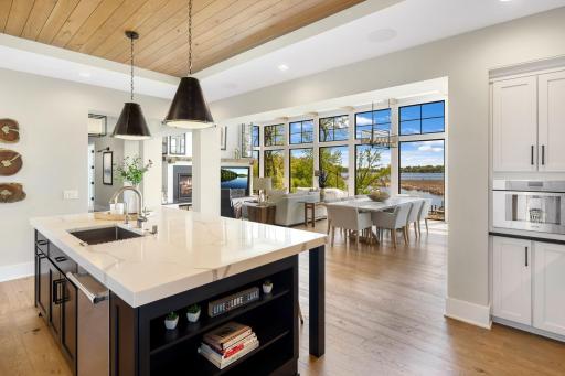 The kitchen flows seamlessly into the bright dining area.