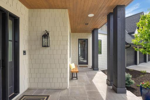 A view of the front porch, with sightlines to the side entrance leading into the mudroom.