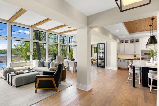 The light-filled main level features an open layout with soaring 12-foot ceilings and dramatic floor-to-ceiling Marvin windows.