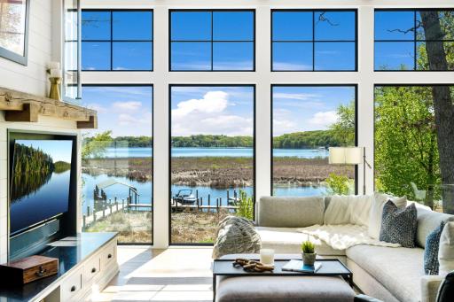 The windows frame breathtaking views of the backyard and Lake Minnetonka.
