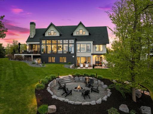 The outdoor living space includes a 33x18 paver patio, roughed in for a hot tub, a 20x20 firepit area perfect for summer evenings, and a maintenance-free deck.