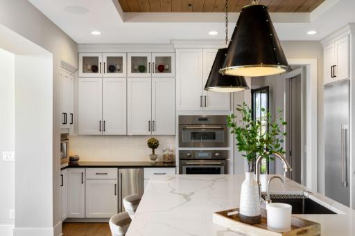 Premium stainless steel Thermador appliances include separate refrigerator and freezer columns, a Scotsman ice maker, and a built-in espresso and coffee machine.