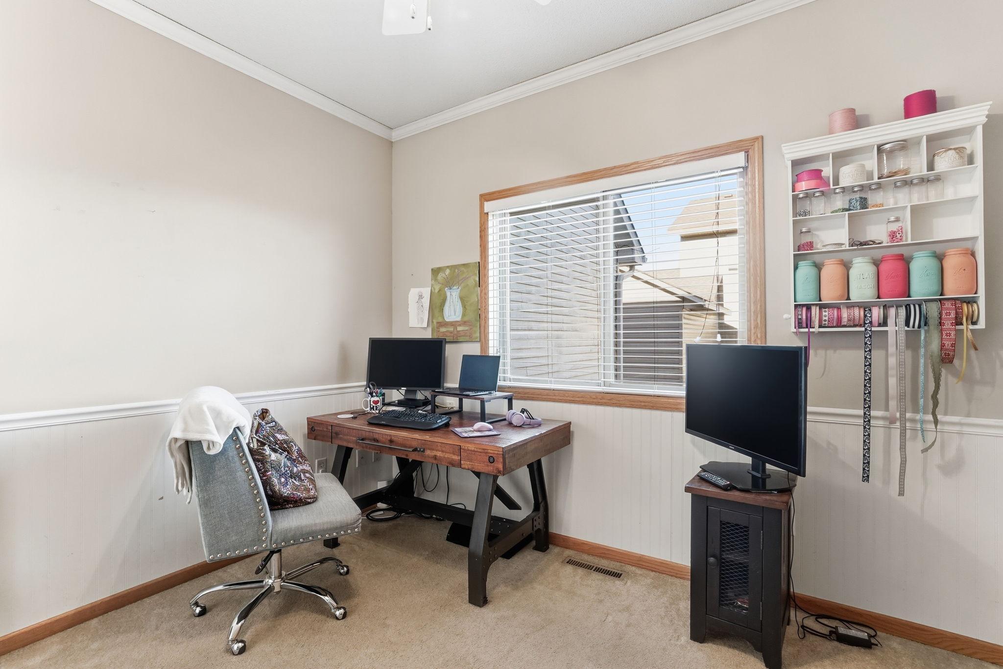 Flexible main-level bedroom ideal for an office or guest room.