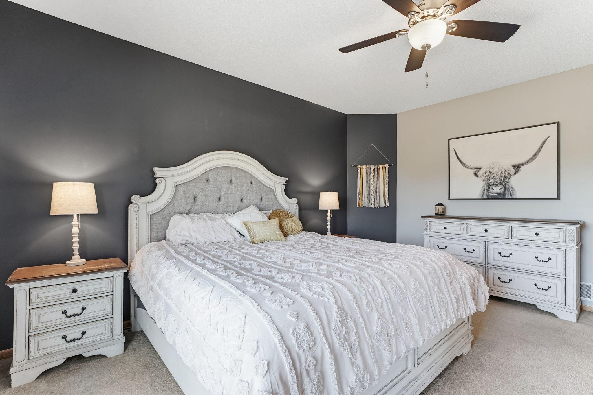 Primary bedroom featuring a ceiling fan.