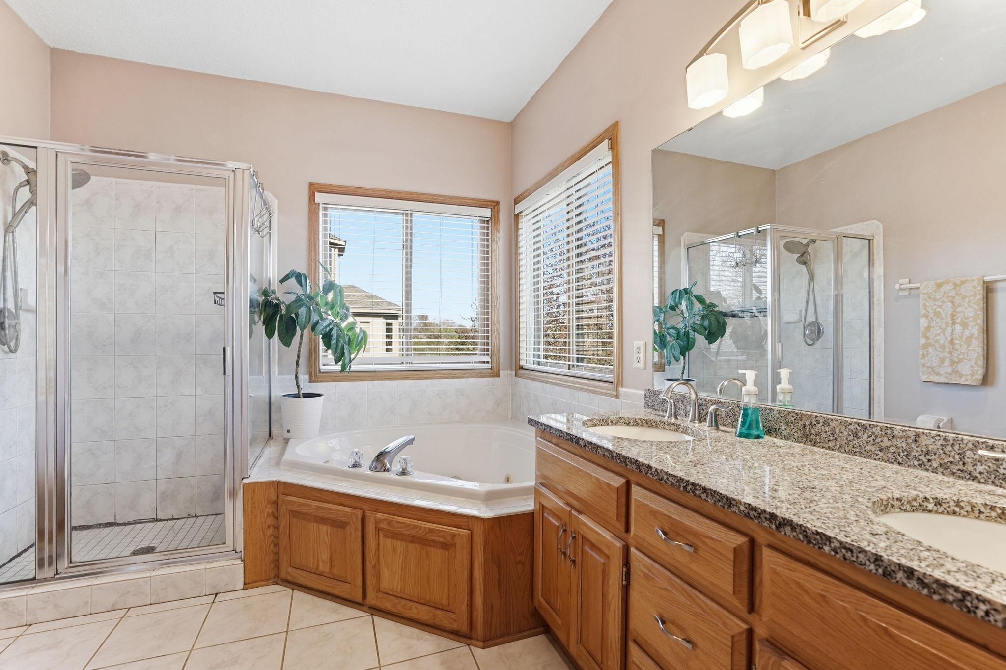 Enjoy a private full bathroom with a jetted tub, separate shower, and dual sinks.