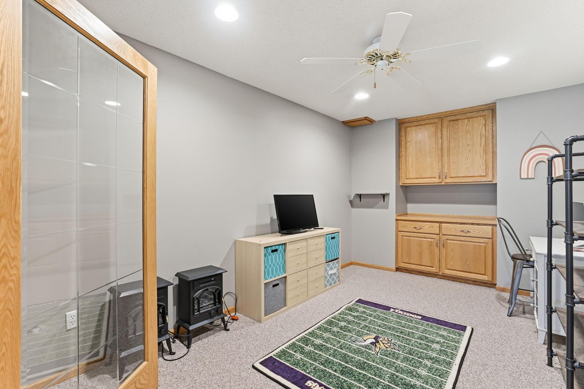 Lower-level office or craft room with double glass doors.