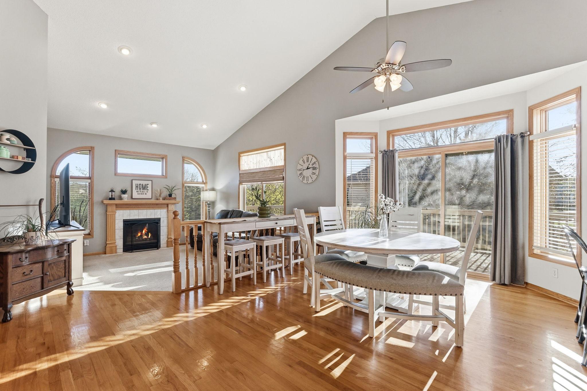 Hardwood floors and plentiful light create a bright, inviting dining and living space.