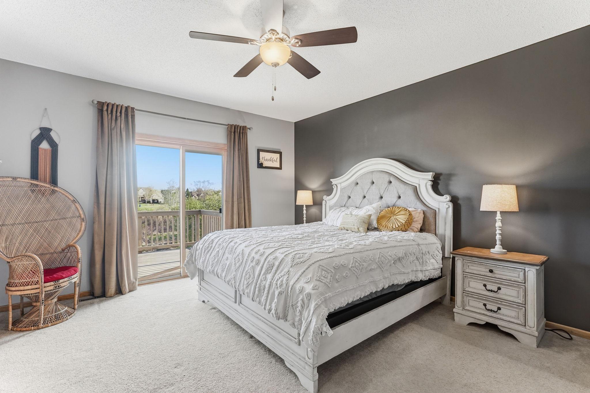 Expansive main level primary suite offering a secluded deck space.