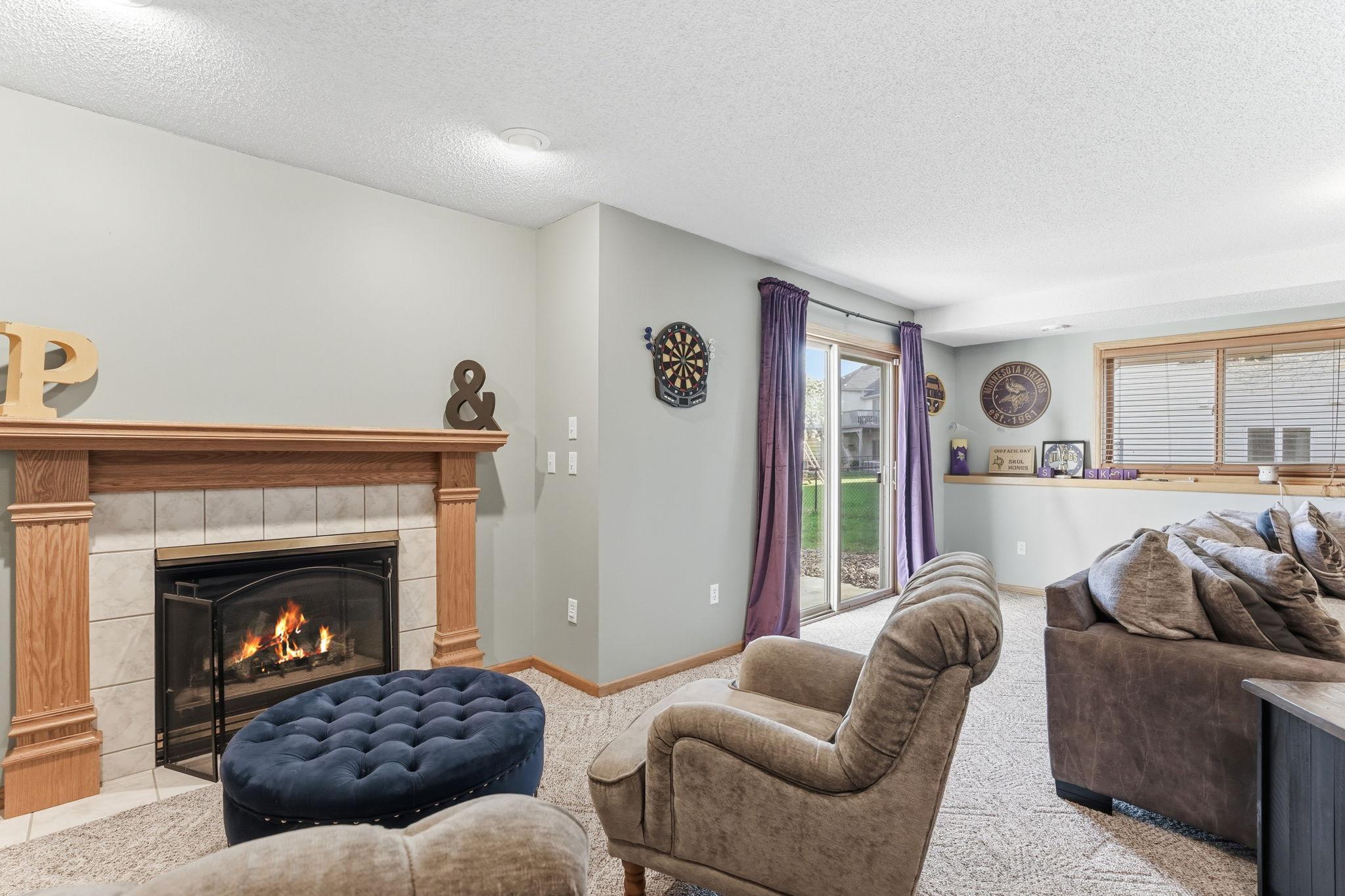 Gas fireplace adds warmth to the lower-level living area.
