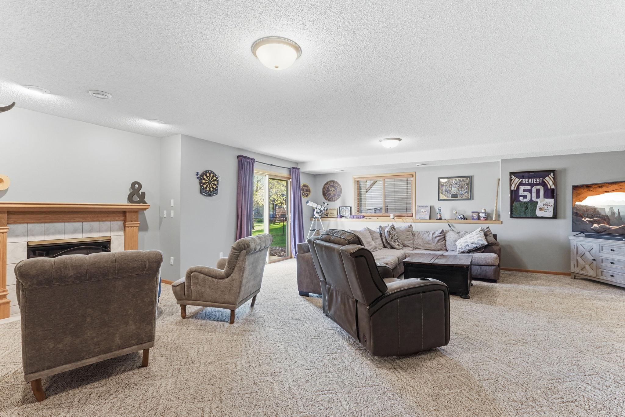 Cozy lower-level living area featuring a walkout to the backyard.