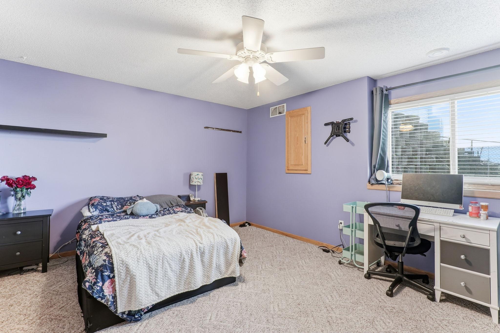 Generous fourth bedroom with added ceiling fan comfort.