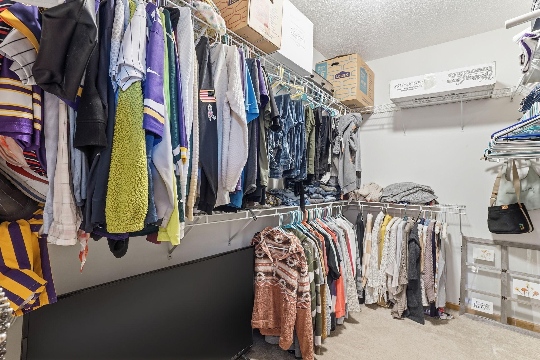 Spacious walk-in closet with room to spare for clothing and storage.