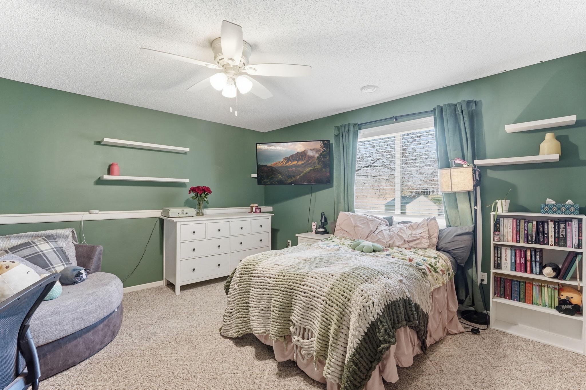 Oversized third bedroom on the lower level with added ceiling fan comfort.