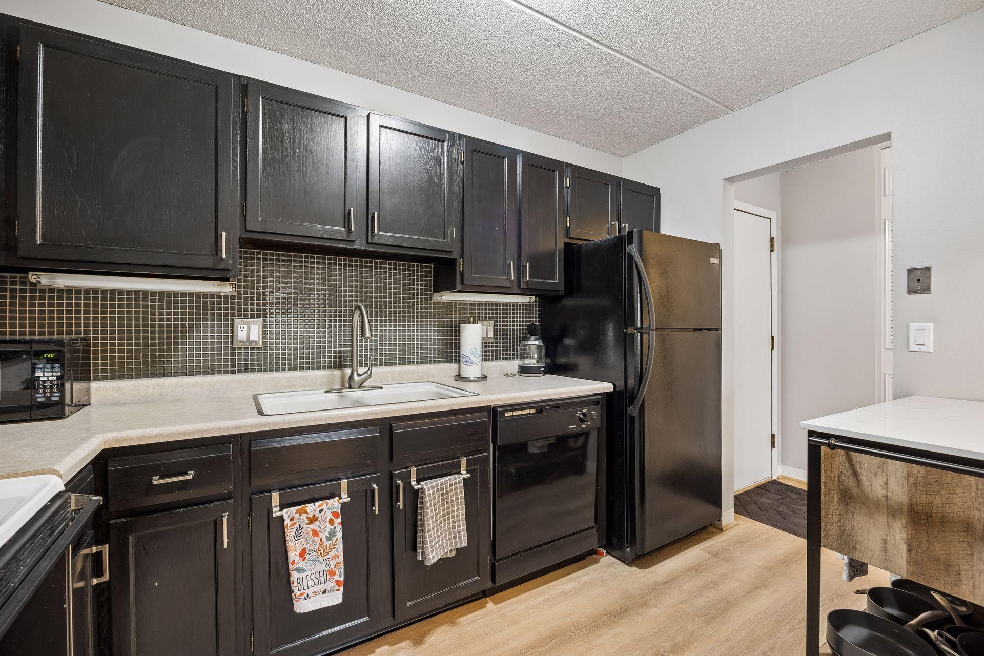The kitchen was updated in 2022 with new flooring, enameled cabinetry and a stylish backsplash.