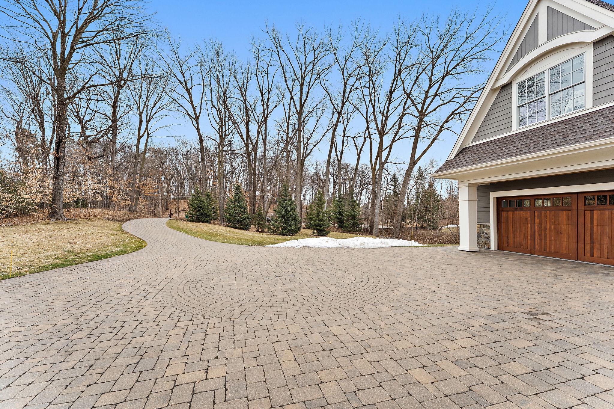 Beautiful long paver driveway with built-in lighting