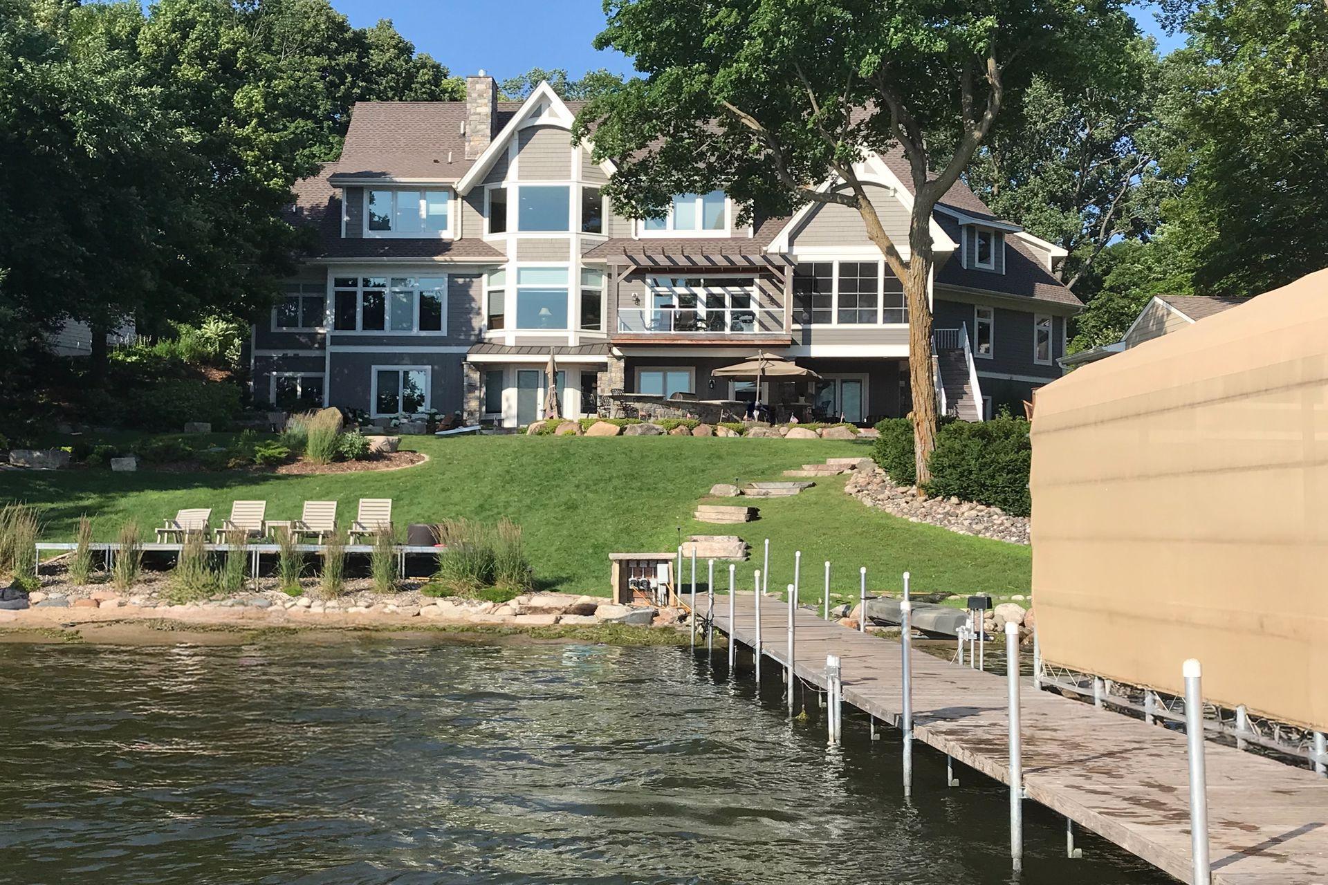 Summer view showcasing the 98-foot dock; both boat canopies have since been updated and one can accommodate a larger vessel