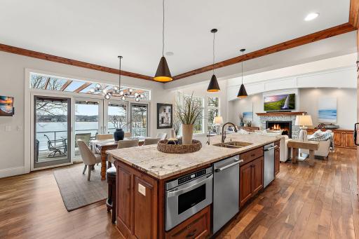 Main-level kitchen featuring Cambria countertops, double dishwasher, and sweeping views of Lake Minnetonka
