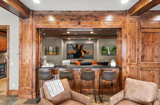 Theater room with a true cinematic experience and built-in pocket window for expanded viewing, creating the ultimate game day and entertainment space