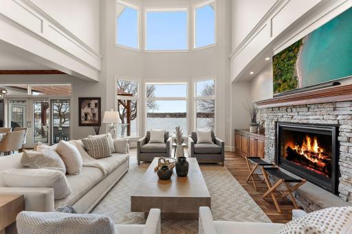 The great room welcomes you with soaring ceilings and picturesque lake views