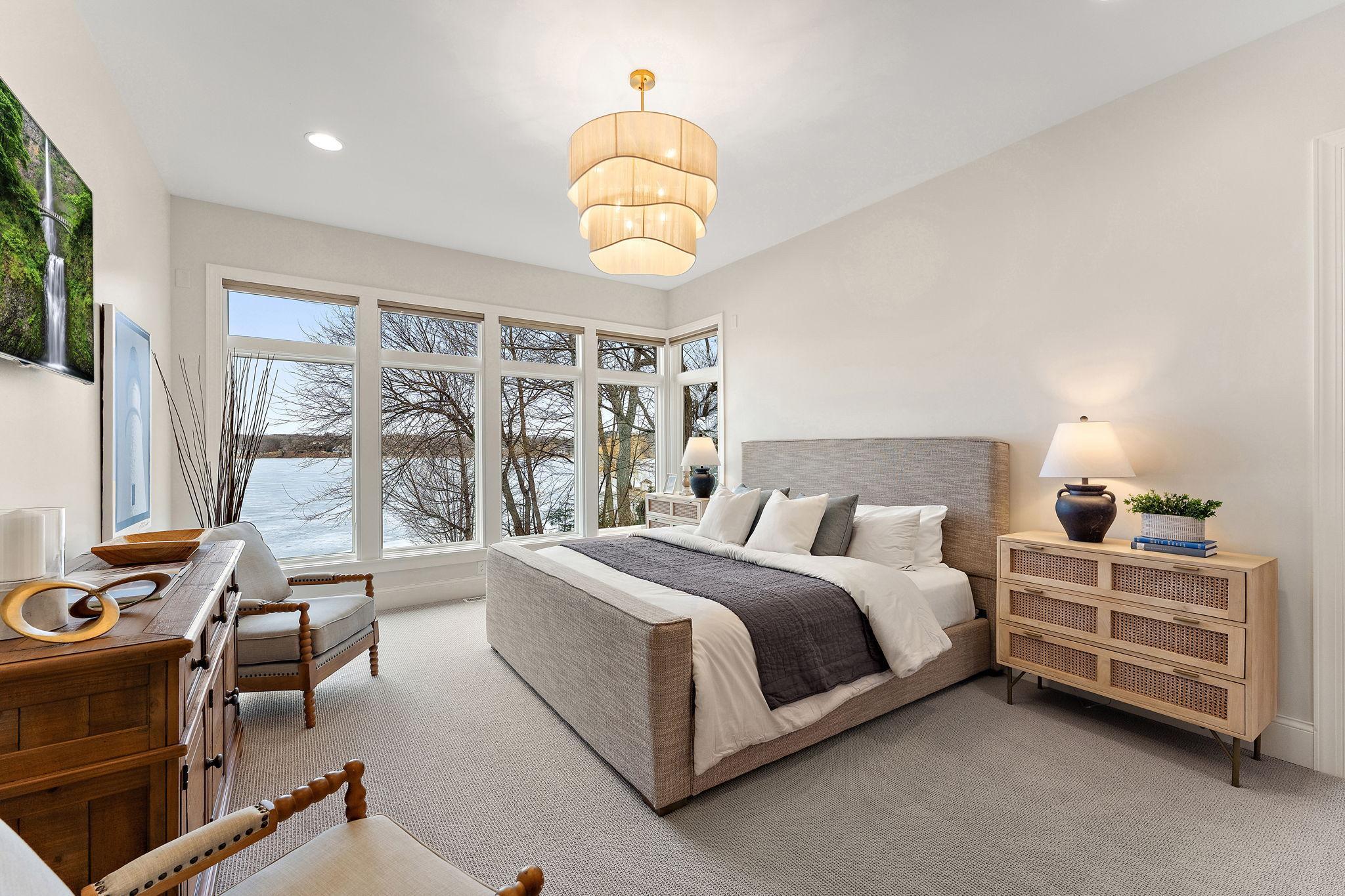 Main-level primary suite #1 designed as a private retreat with a spa-inspired ensuite bath, custom walk-in closet, complemented by fresh paint and new carpet