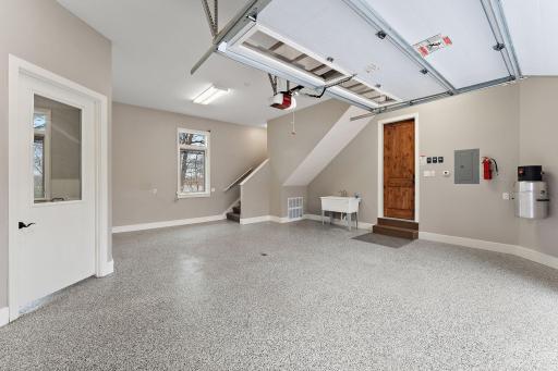 Versatile storage or hobby room with water access, wash tub, and private entrance to the in-law suite