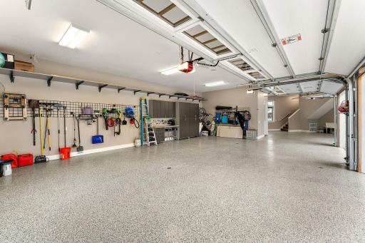 Over-sized heated 4-car garage with work bench and built-in cabinetry