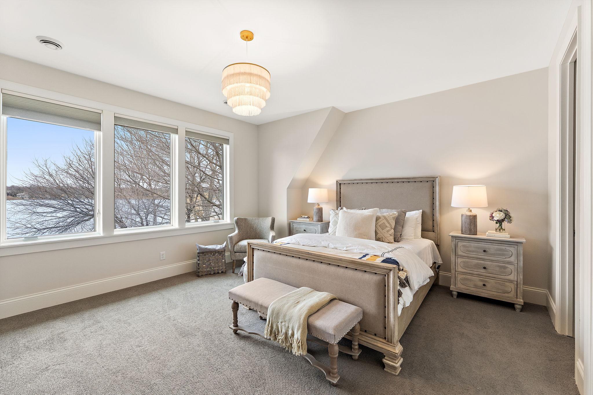 Upper-level suite #2 with ensuite, walk-in closet, and breathtaking lake views