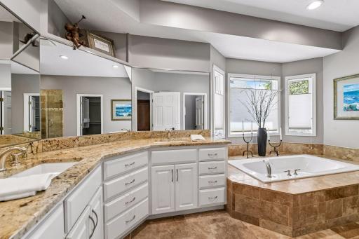 Private, updated primary bathroom with heated floors