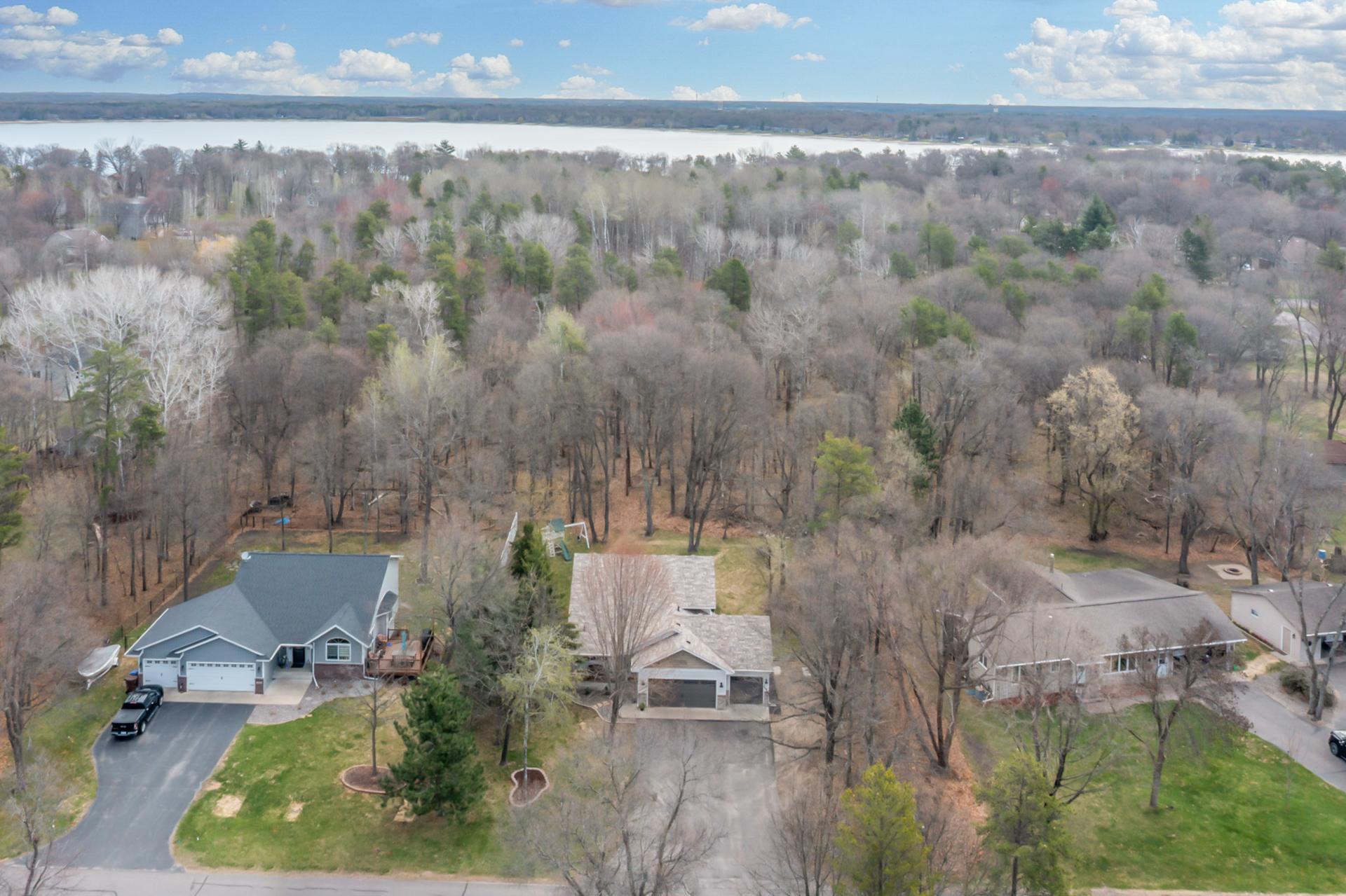 Stunning aerial perspective showcasing the home’s impressive curb appeal and picturesque setting