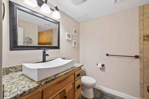 Lower level updated 3/4 bathroom with granite vanity top, stylish square vessel and modern finishes, plus fully tiled shower!sink