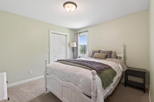 This is the 2nd bedroom on the main level (3 bedrooms on one level and a 4th on the lower level), neutral carpet, white trim and doors.