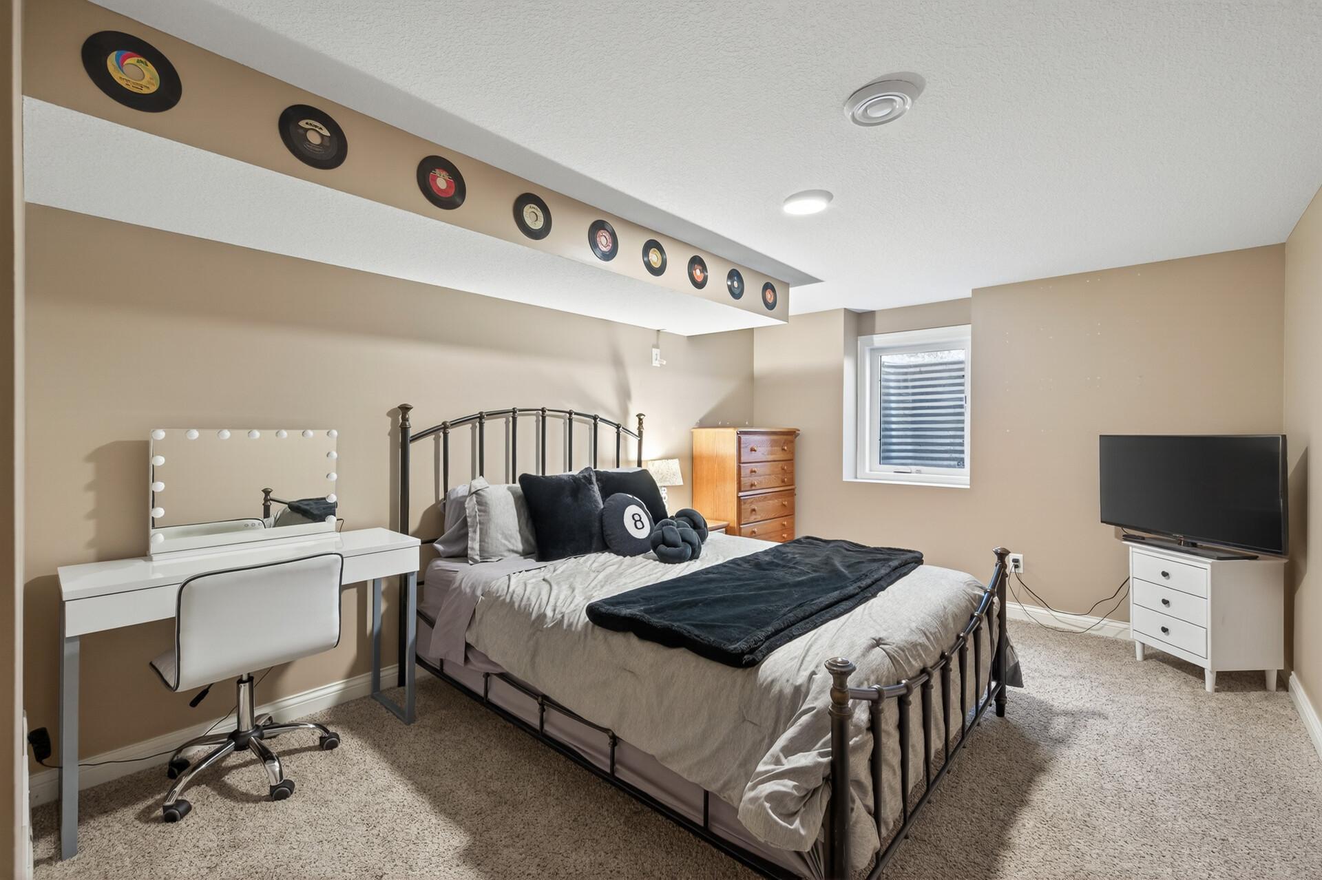The 4th bedroom is located in the lower level with egress window, neutral carpet & paint, plus