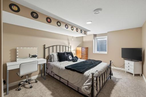 The 4th bedroom is located in the lower level with egress window, neutral carpet & paint, plus