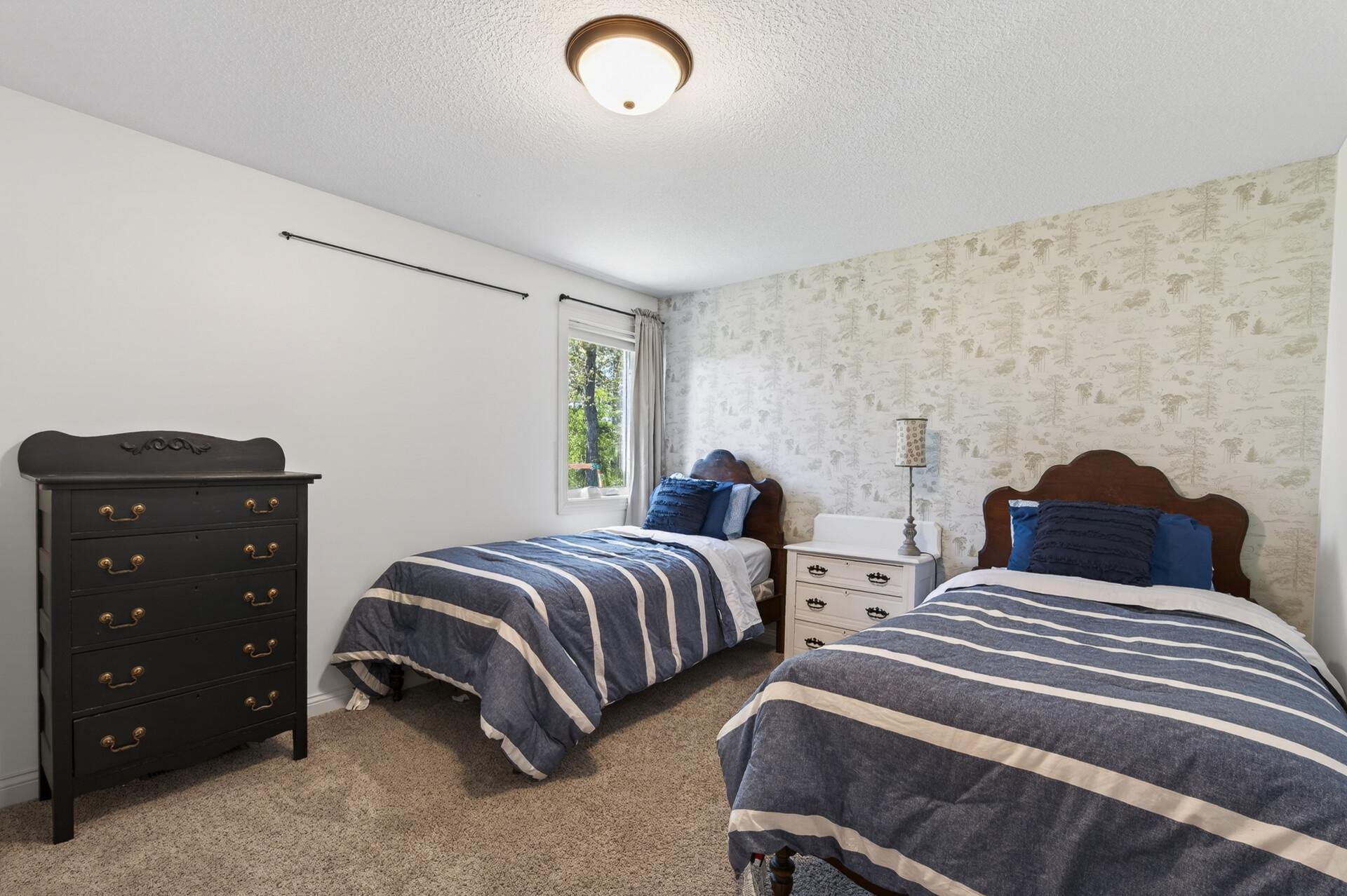 This is the 3rd bedroom, and located on the main level (3 bedrooms on one level and 4th in lower), neutral carpet and paint.