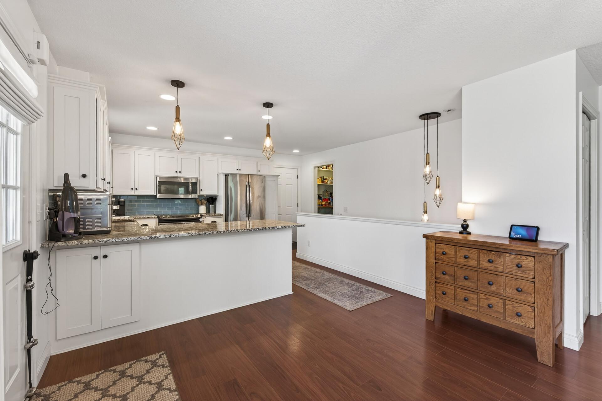 Front entry leads into the open kitchen and dining area...lots of natural light in this rambler home!