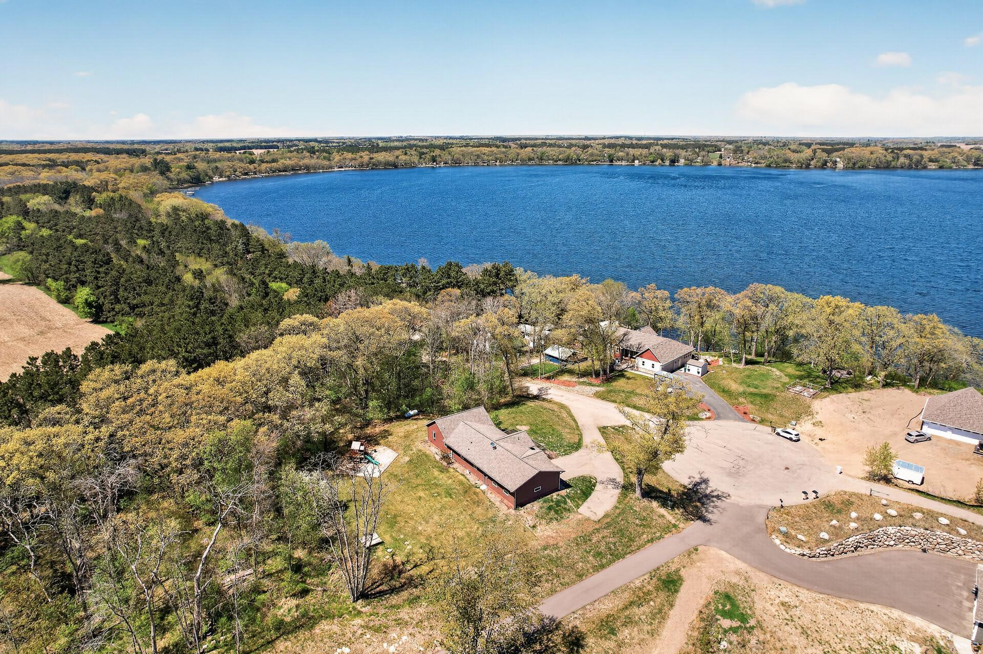 Aerial view of the side rearview of home looking northwest across Green Lake.
