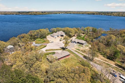 Aerial view from the southwest looking northeast across the lake, rearview of the home and full culdesac view.