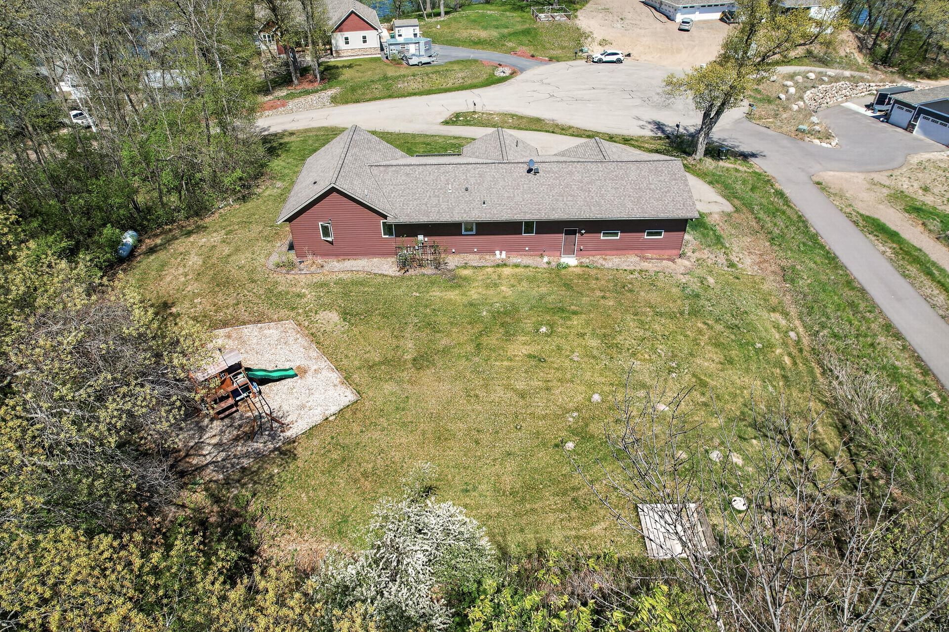 Aerial rearview of the home and backyard.